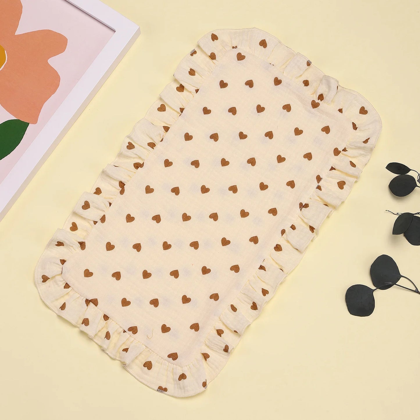 Infant care essential: a soft gray cotton gauze burp cloth with a sweet ruffle edge, great for spit-ups.