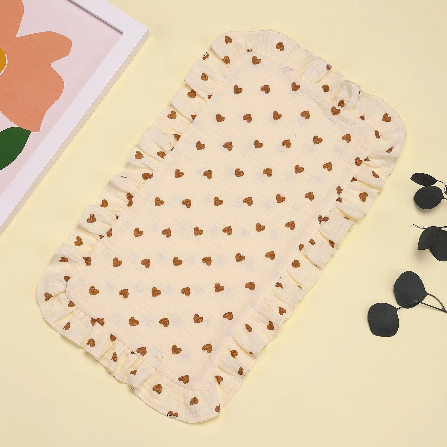 Infant care essential: a soft gray cotton gauze burp cloth with a sweet ruffle edge, great for spit-ups.