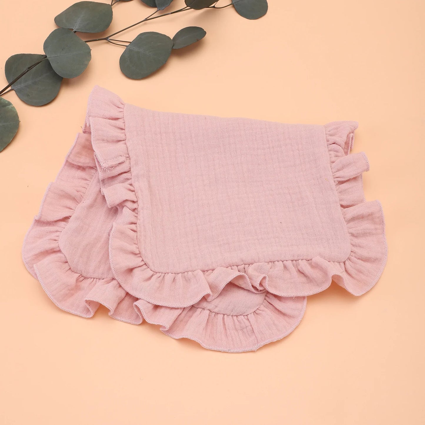 Display of various colored muslin cotton gauze burp cloths with ruffle edges, perfect for baby shower gift.