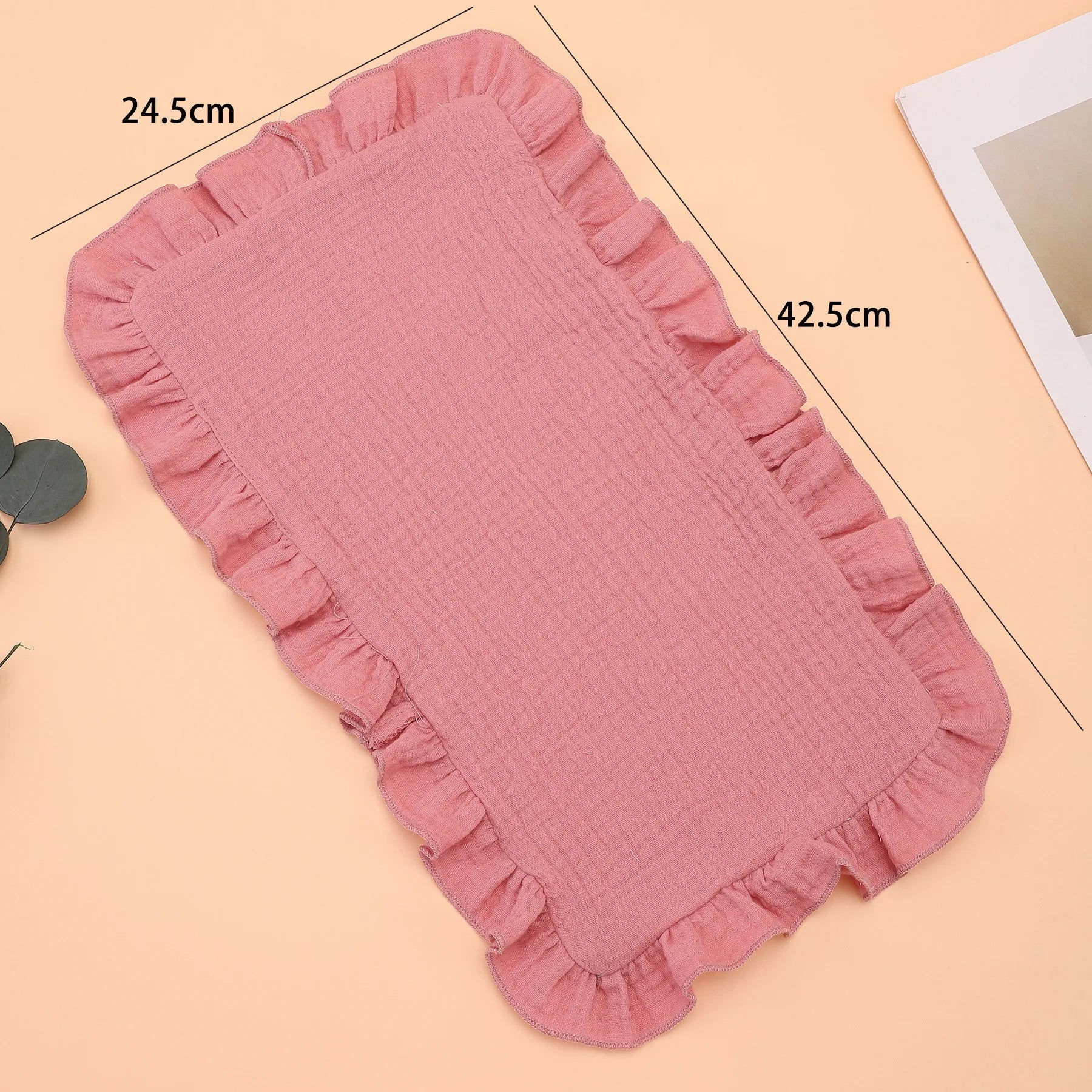Folded lavender muslin cotton gauze burp cloth featuring a charming ruffle edge, a must-have baby accessory.