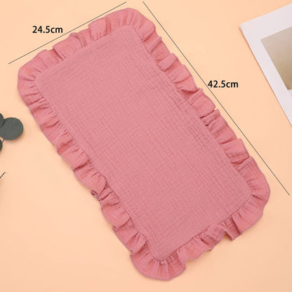 Folded lavender muslin cotton gauze burp cloth featuring a charming ruffle edge, a must-have baby accessory.