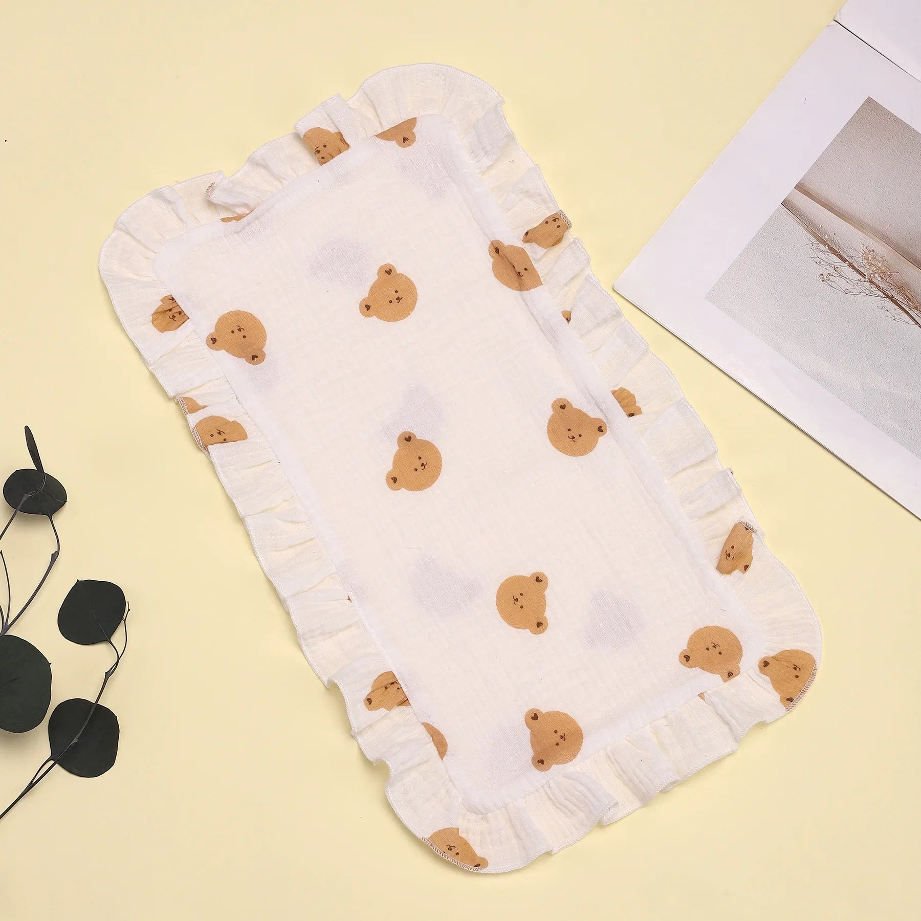 Stack of colorful muslin gauze burp cloths with ruffle edges, soft and absorbent for baby feeding & burping.