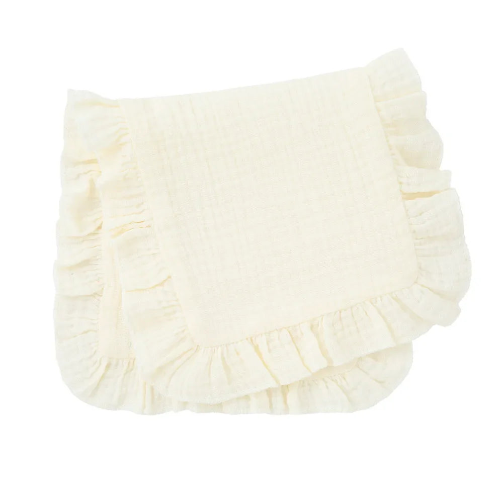 Close-up of the elegant ruffle edge design on a soft white muslin baby burp cloth, comfortable.