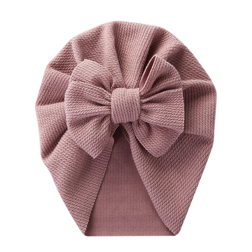 Soft pink topknot turban hat for infant, stretchy polyester baby headwrap fashion accessory