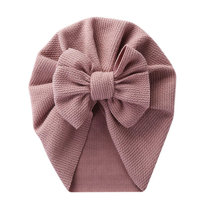 Soft pink topknot turban hat for infant, stretchy polyester baby headwrap fashion accessory