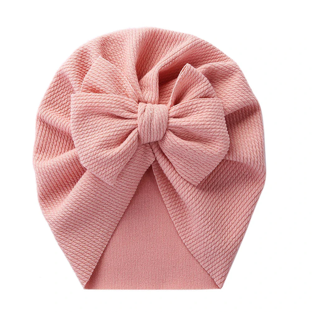 Close-up texture of a baby topknot turban hat, premium soft polyester fabric
