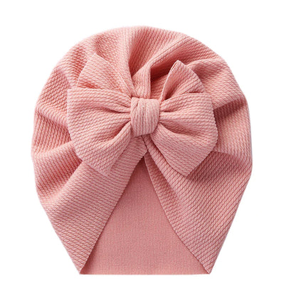 Close-up texture of a baby topknot turban hat, premium soft polyester fabric