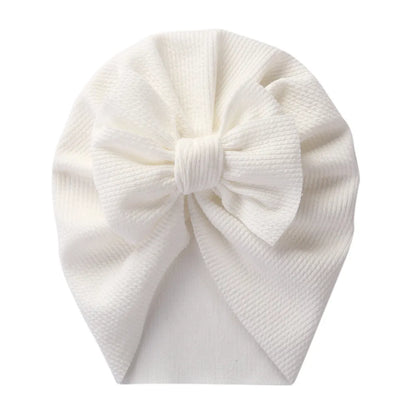 Infant in a patterned topknot turban, fashionable polyester baby headwrap accessory