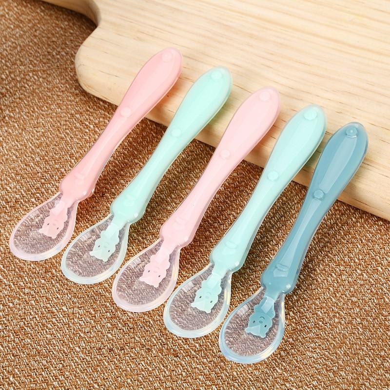 Soft silicone baby spoon, ergonomic, for independent self-feeding. Gum-friendly toddler utensil for infant care.