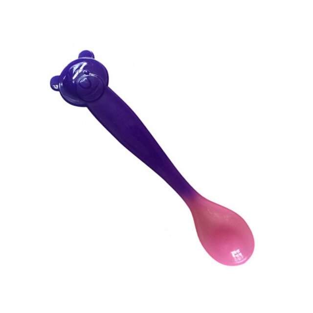 Baby silicone feeding spoon next to a bowl of pureed food, ready for an infant's self-feeding experience.