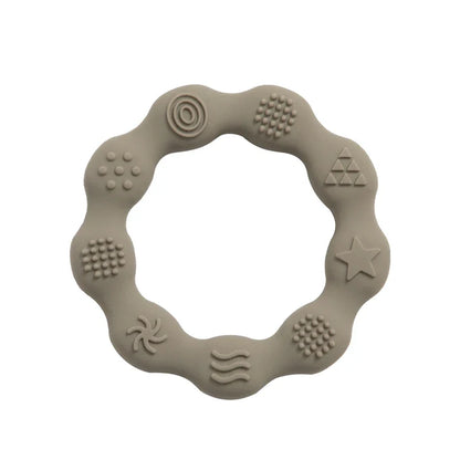 Infant silicone teether with integrated grip handle, promoting self-soothing ability