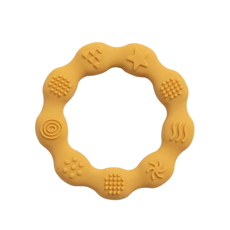 Baby holding an easy-grip silicone teether, promoting independent oral exploration