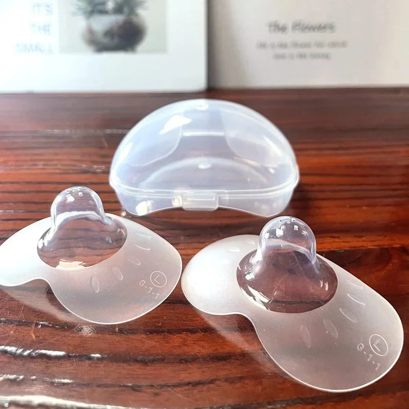 Silicone nipple protectors, a 2-pack for breastfeeding and nursing comfort, aiding in baby feeding.