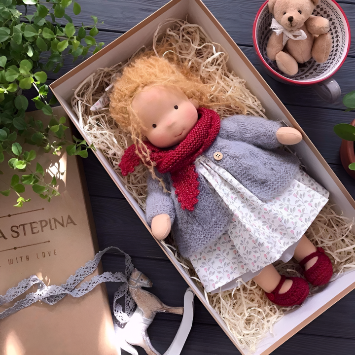 Waldorf doll made from organic cotton and wool, a soft and educational toddler toy.