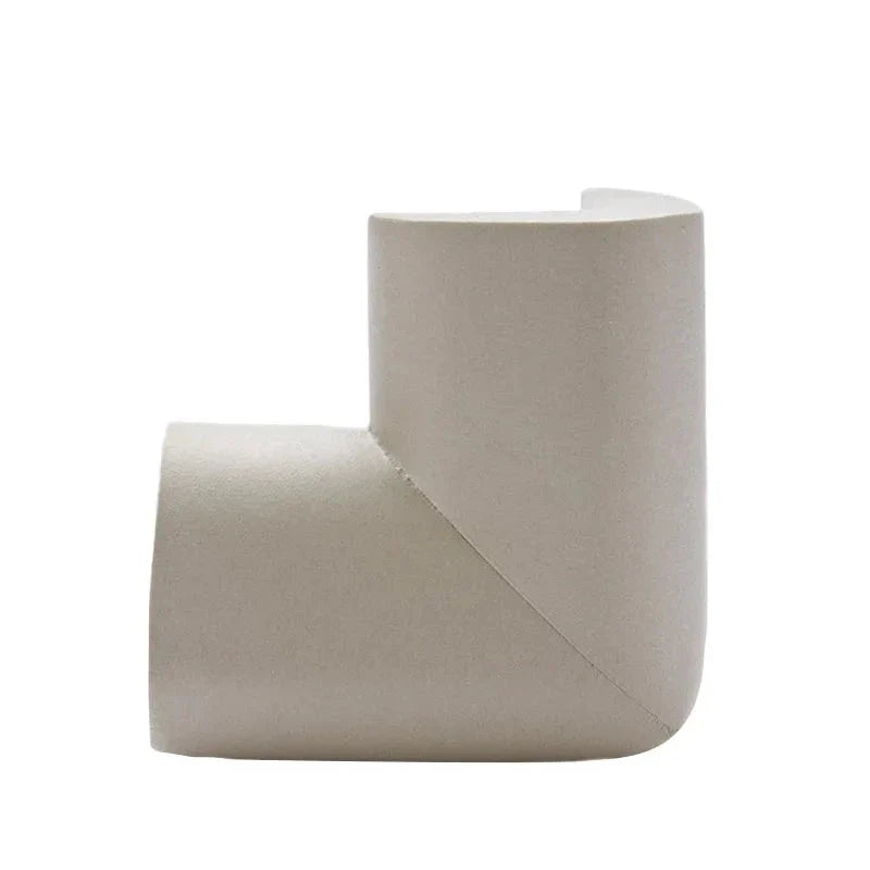A room with multiple pieces of furniture fitted with baby safety corner guards for toddler protection.