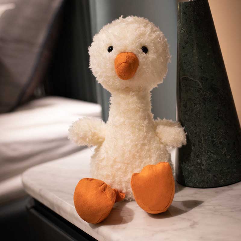 White lamb stuffed animal plush comfort pillow on a bed, perfect kids toy for sleeping