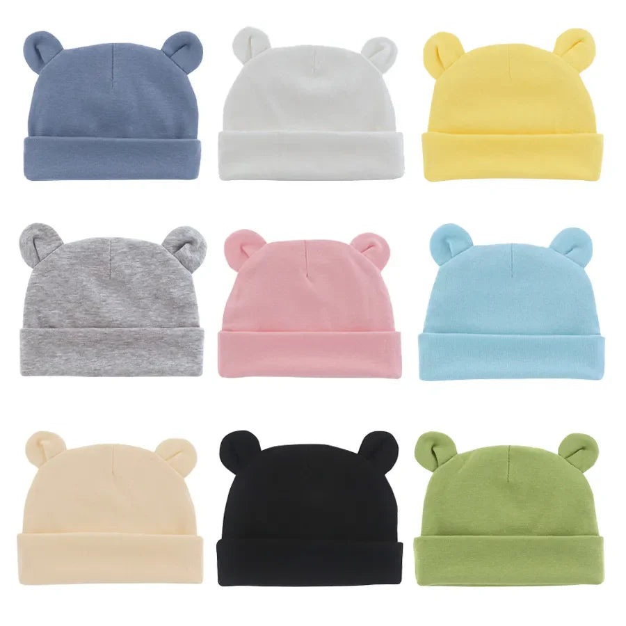 Soft white cotton baby beanie hat for newborns 0-12 months, perfect baby shower gift.
