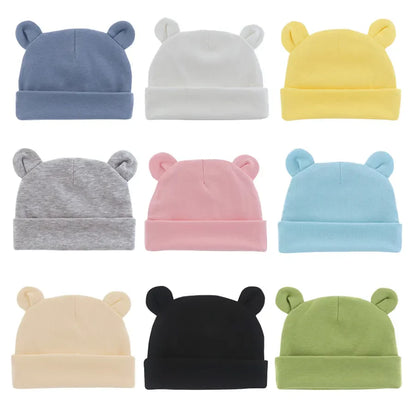 Soft white cotton baby beanie hat for newborns 0-12 months, perfect baby shower gift.