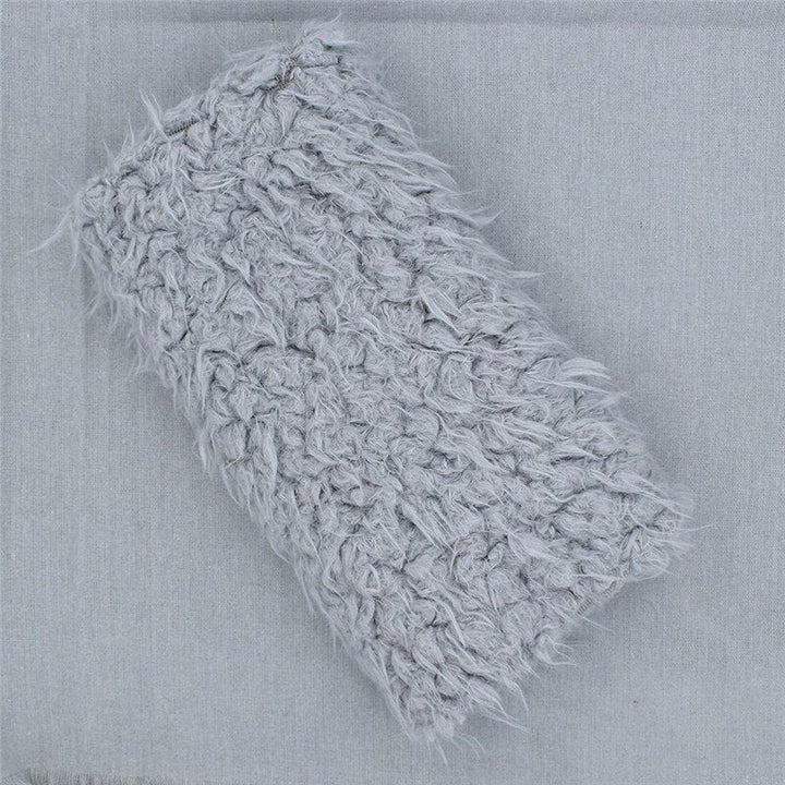 Plush faux fur newborn blanket, a cozy photography prop. Soft baby accessory for keepsake photo shoots.