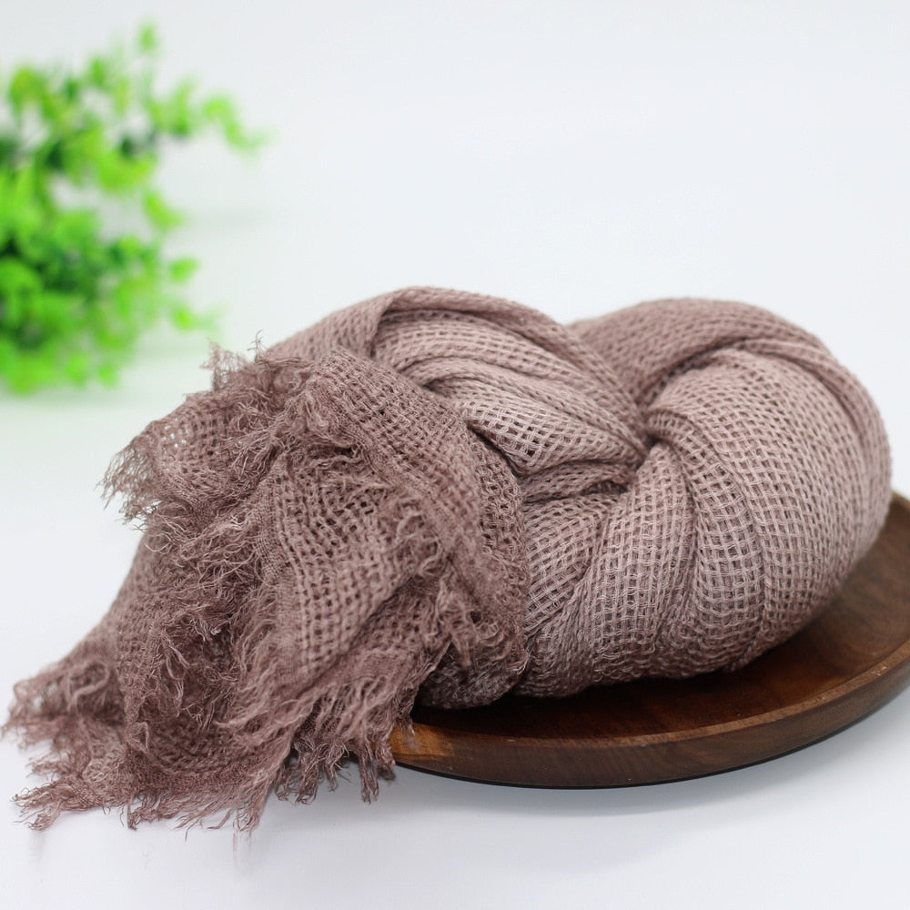 Pink knit newborn swaddle blanket, a cozy baby accessory and adorable photo prop for infants.