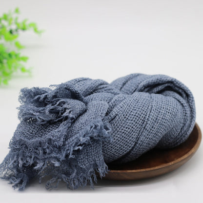 Infant wrapped in a blue knitted baby swaddle blanket, great for newborn photo ops & comfort.