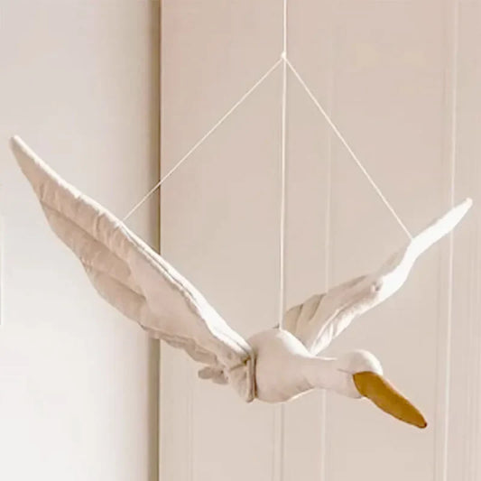 Soft white plush swan hanging decor, perfect for a baby nursery or kids room wall decoration.