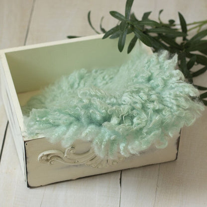 Textured wool baby blanket, soft photo backdrop for newborn photography studio.