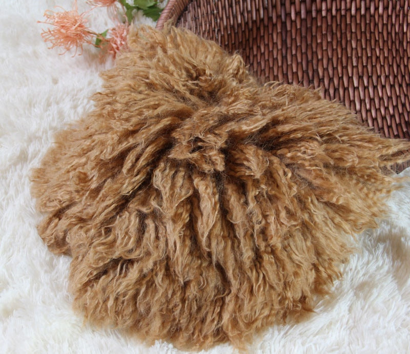 Newborn posing blanket made of plush wool, a cozy baby photography accessory.