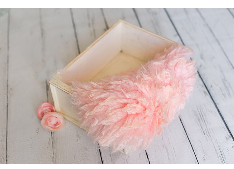 Hand-knitted wool blanket, essential infant photo prop for professional photography.