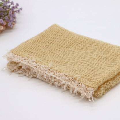 Beige baby photography swaddle blanket, a cozy newborn prop for professional infant photo sessions.