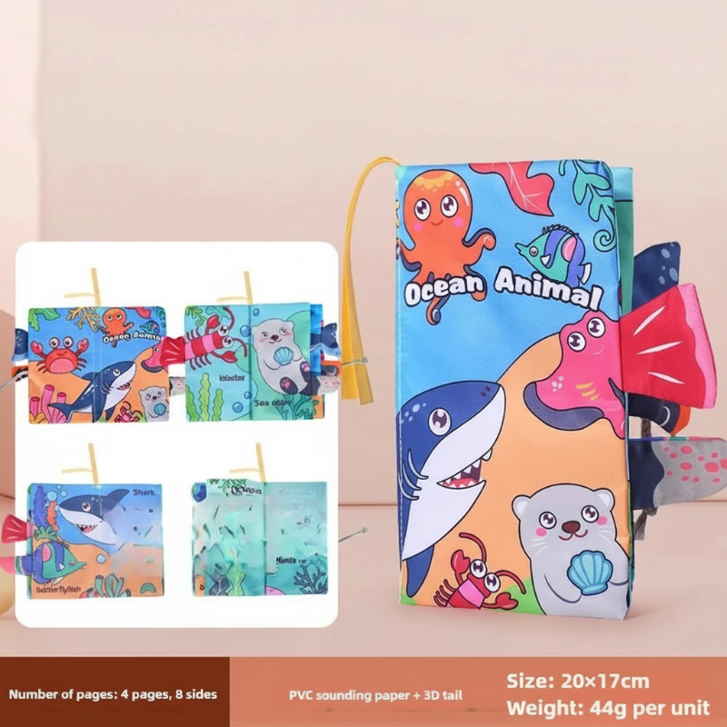 Happy baby looking at the interactive pages of a SoftTails fabric book, infant learning
