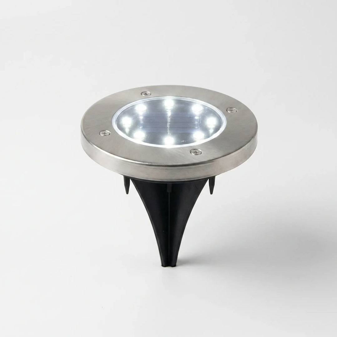 Waterproof solar disk lights for outdoor garden and landscape illumination.