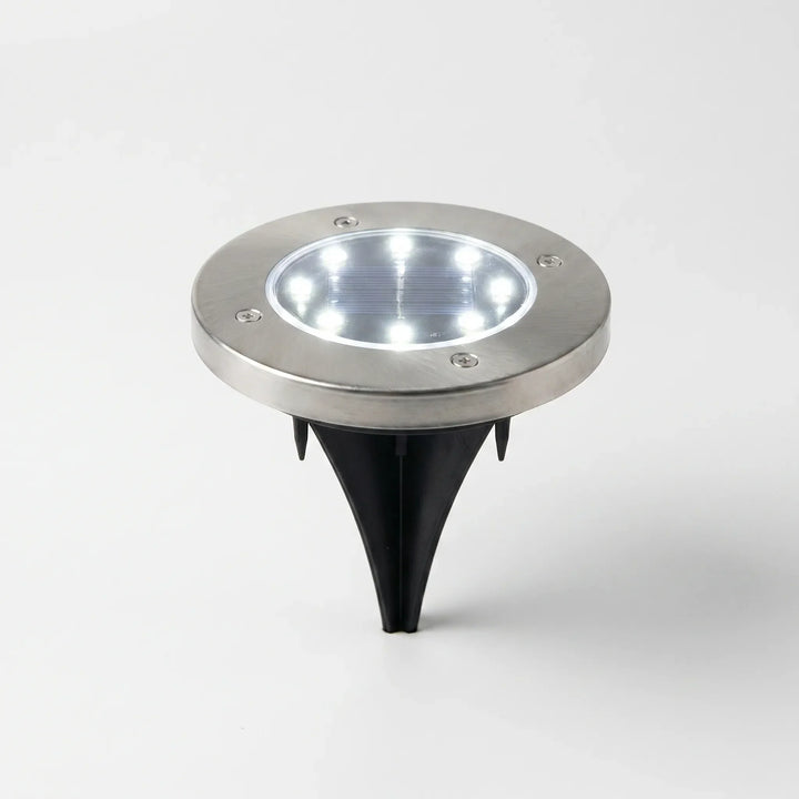 Waterproof solar disk lights for outdoor garden and landscape illumination.