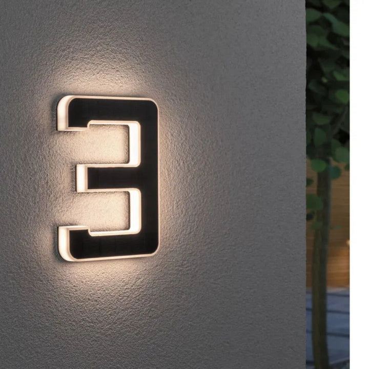 Weather resistant illuminated address sign with solar power for night visibility.