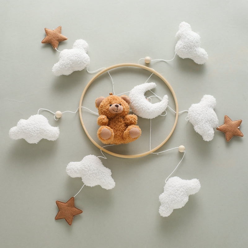 Close-up of a bear and stars baby mobile, ideal for sensory play and crib decor.