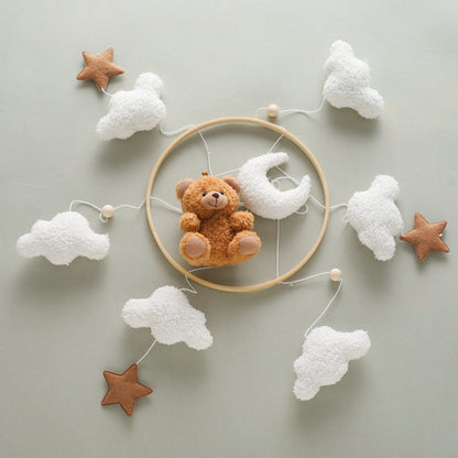 Close-up of a bear and stars baby mobile, ideal for sensory play and crib decor.