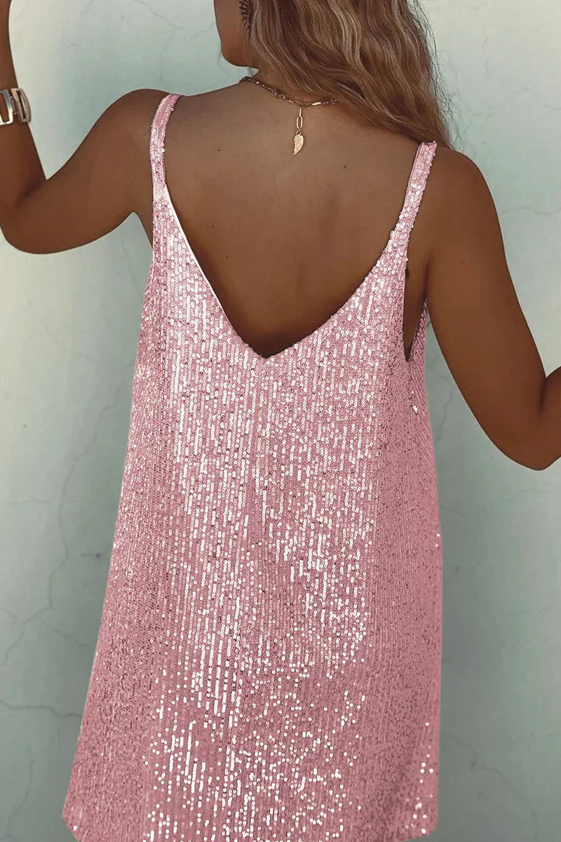 Woman posing in sparkling sequin V-neck mini dress. Glamorous party & evening fashion for special events.