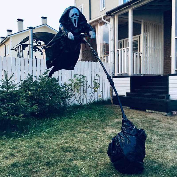 Spooky hanging ghost scarecrow Halloween decoration with flowing white shroud, perfect for outdoor decor