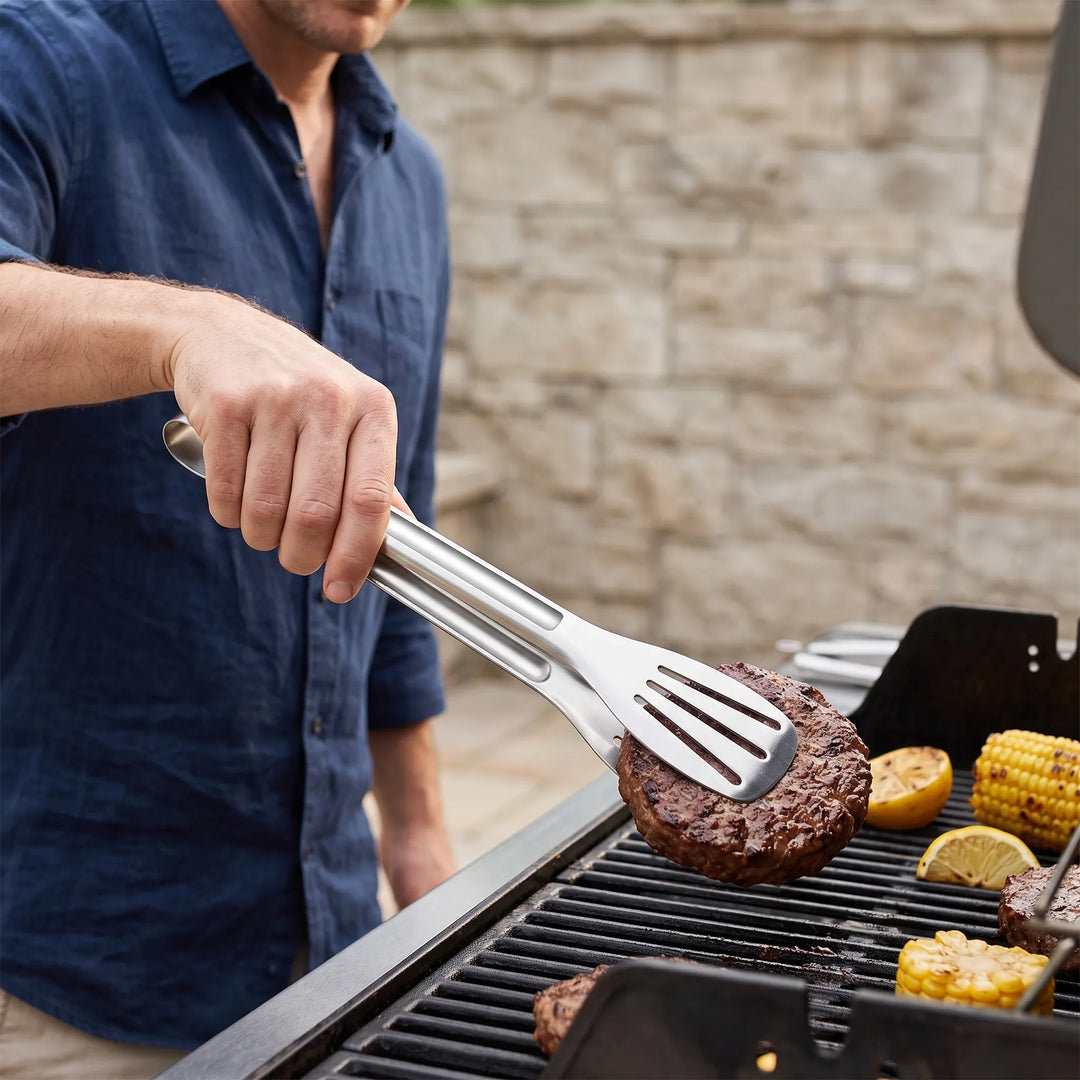 Stainless steel slotted kitchen tongs for precise cooking & serving. Durable, non-slip grip, ideal for grilling.