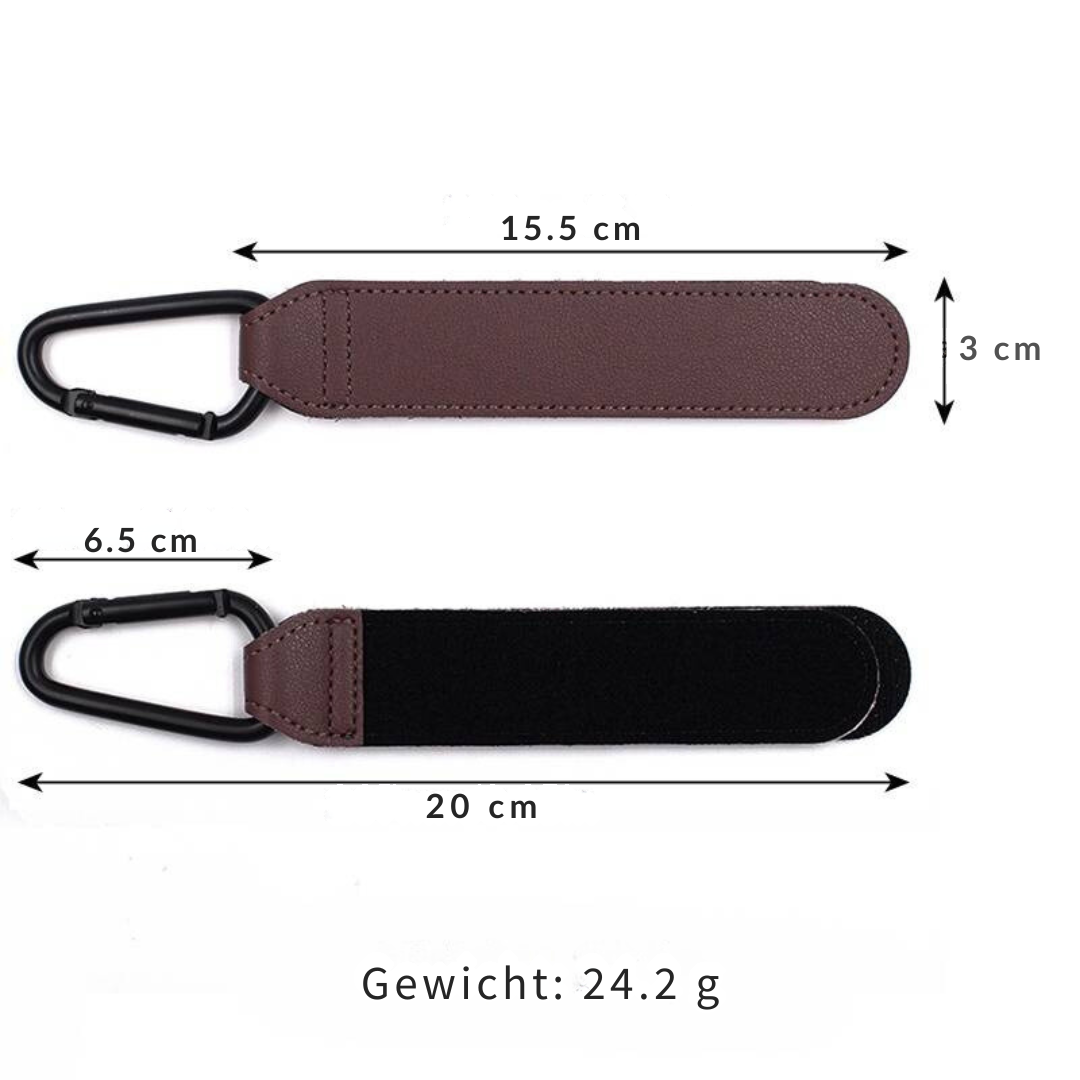 Two black vegan leather stroller hooks securely attached to a pram handle, holding a diaper bag.