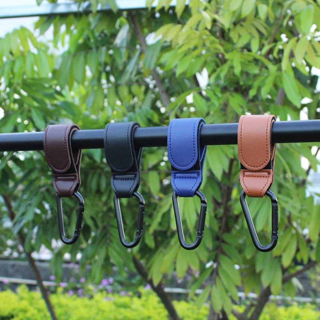 Stylish and practical black vegan leather stroller hooks for carrying groceries and baby items.
