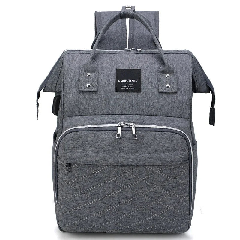 Stylish diaper backpack with gold-tone zippers, adding a touch of elegance