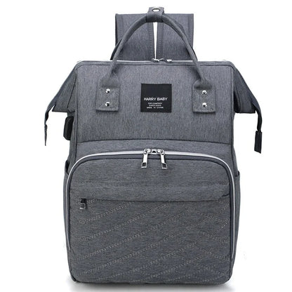 Stylish diaper backpack with gold-tone zippers, adding a touch of elegance