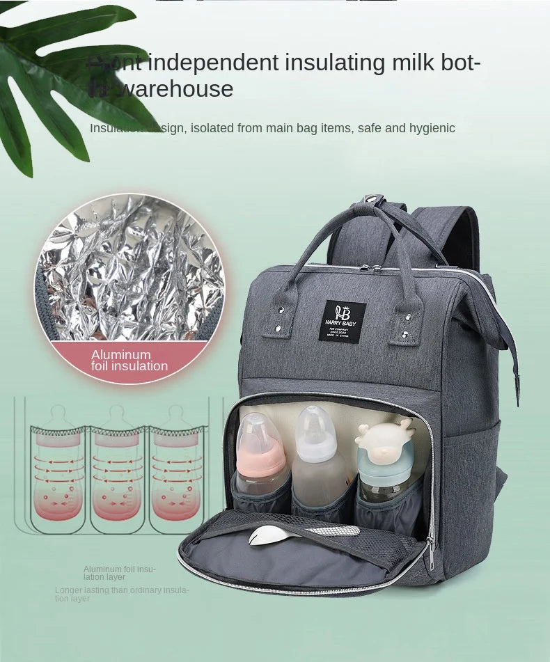 Diaper backpack alongside baby items – bottles, toys, and diapers – organized bag
