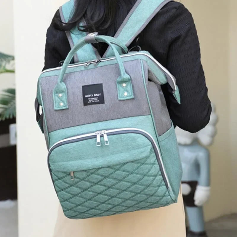Travel diaper backpack in grey, showcasing its spacious design and useful pockets
