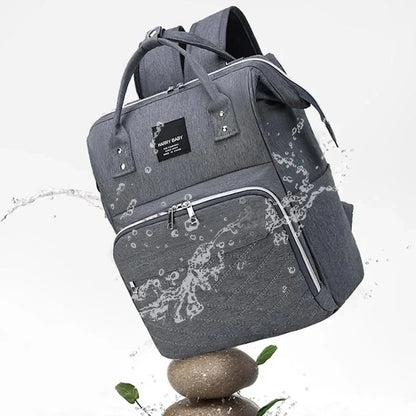 Fashionable mom with a designer diaper bag, essential for baby transport