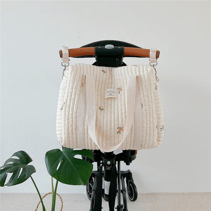 Cotton floral diaper bag, elegant design for baby essentials, attached to stroller