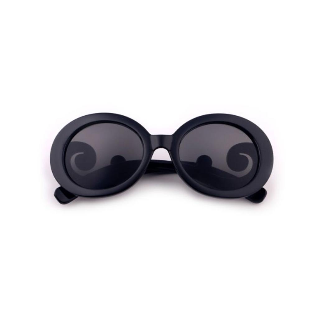 Close-up of black kids' stylish UV protection sunglasses on a summer day background