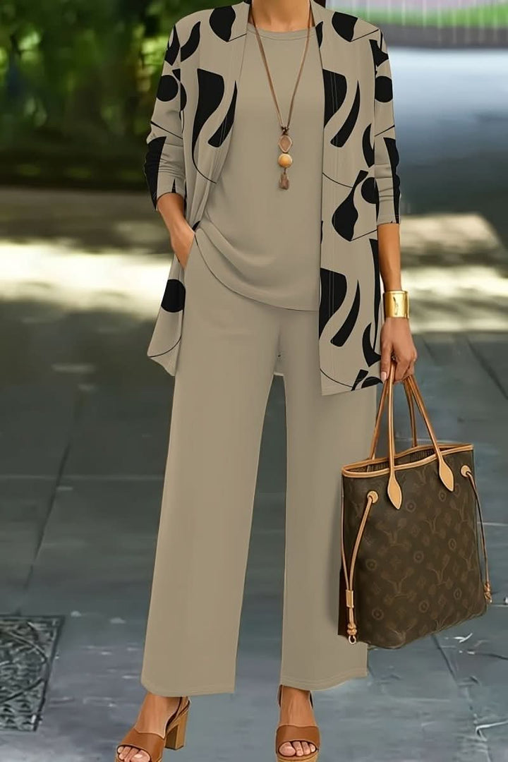 Comfortable women's loungewear set with a unique abstract print, including a matching top, trousers, and jacket.