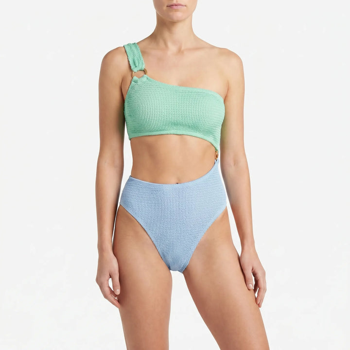 Trendy women's one-piece asymmetric monokini swimsuit featuring a modern cut-out design. Great for resort wear.